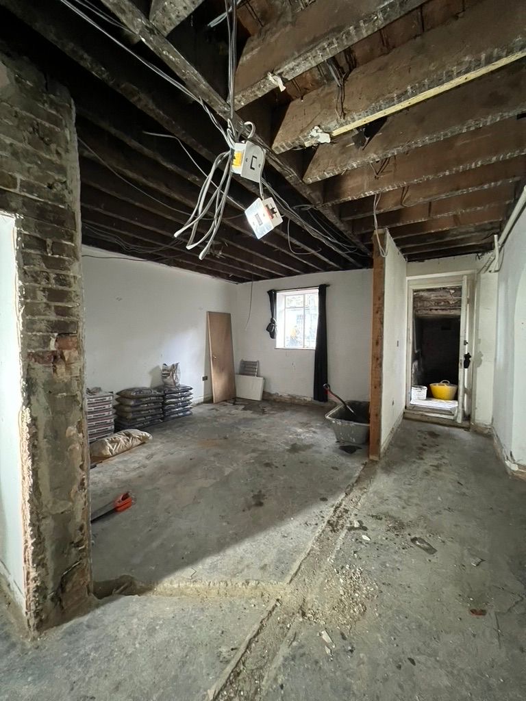 Rear ground floor space with exposed joists and new openings during structural works