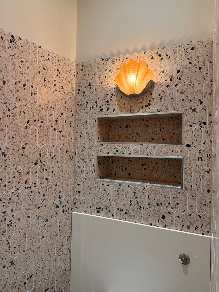 Scallop shell wall light above twin recessed niches in picket terrazzo, Fulham