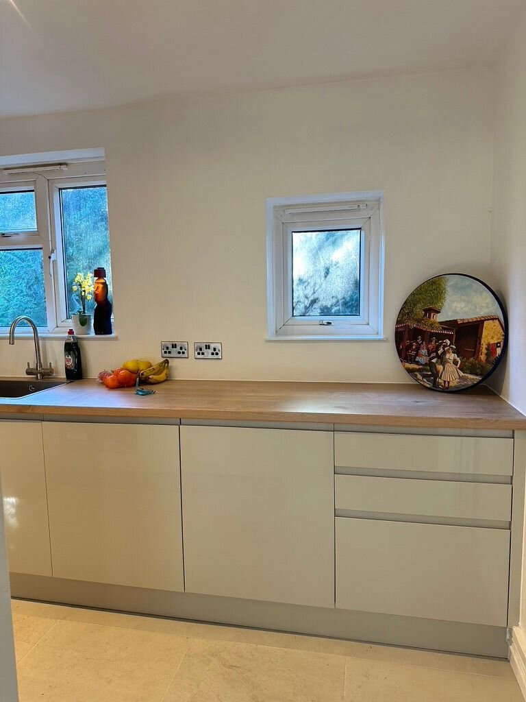 Full-height cream cabinetry housing oven and larder storage, Croydon home renovation
