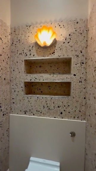 Detail of shell wall light and terrazzo niches above the WC, SW6 cloakroom