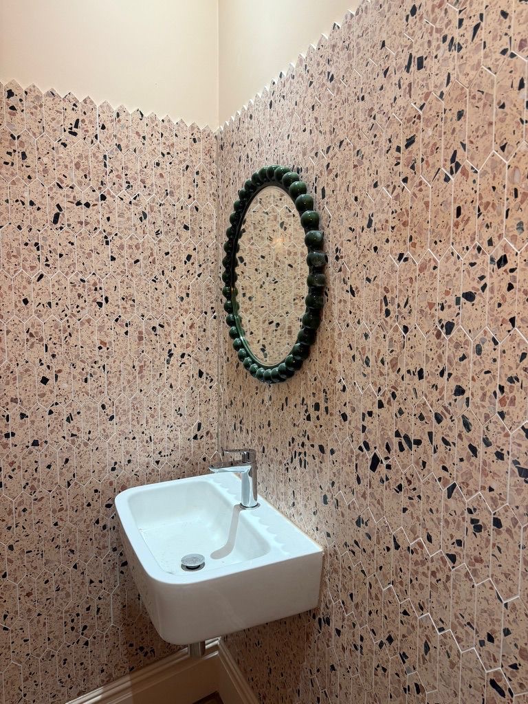 Corner view of Fulham cloakroom with beaded emerald mirror and picket terrazzo tiling