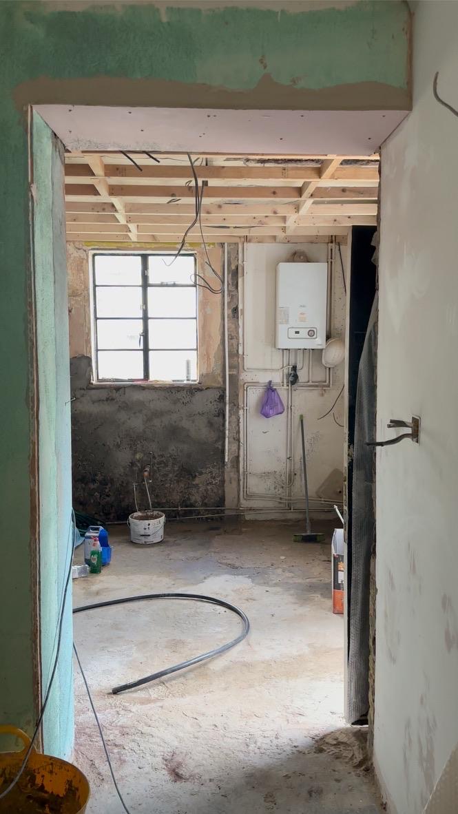 Doorway view through gutted kitchen area before renovation, Kennington
